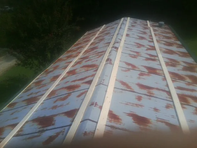 Rusted metal roof panels with new wood purlins before replacement — Storm Damage Roof Repair in Sherman Oaks by Roofing Brothers
